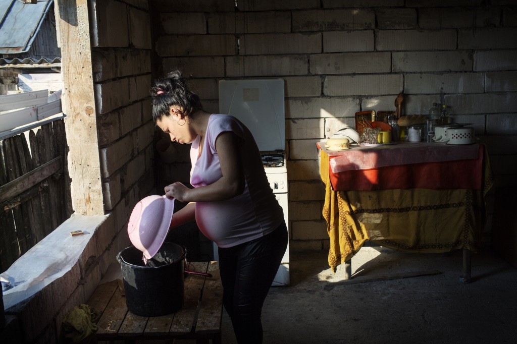 Mariana, an underage mother pregnant with her second child doing daily household chores, as seen in Valcea county, on September 11, 2016.  Mariana was rapped by her step father, to whom she mothered a child and stabbed by her own mother when she learned about the rape. Mariana is part of World Vision program Mothers for Life, Life for Mothers.